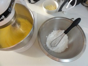 Eggs and sugar being whisked next to dry ingredients