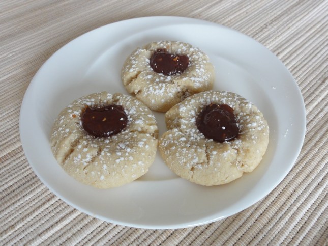 Raspberry almond thumbprint cookies on a plate