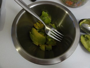 Mashing avocado with a fork