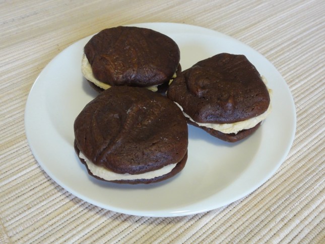 Three sandwich cookies on a plate