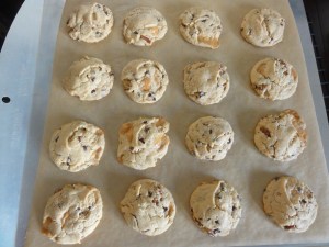 Chocolate chip caramel pecan cookies on a sheet